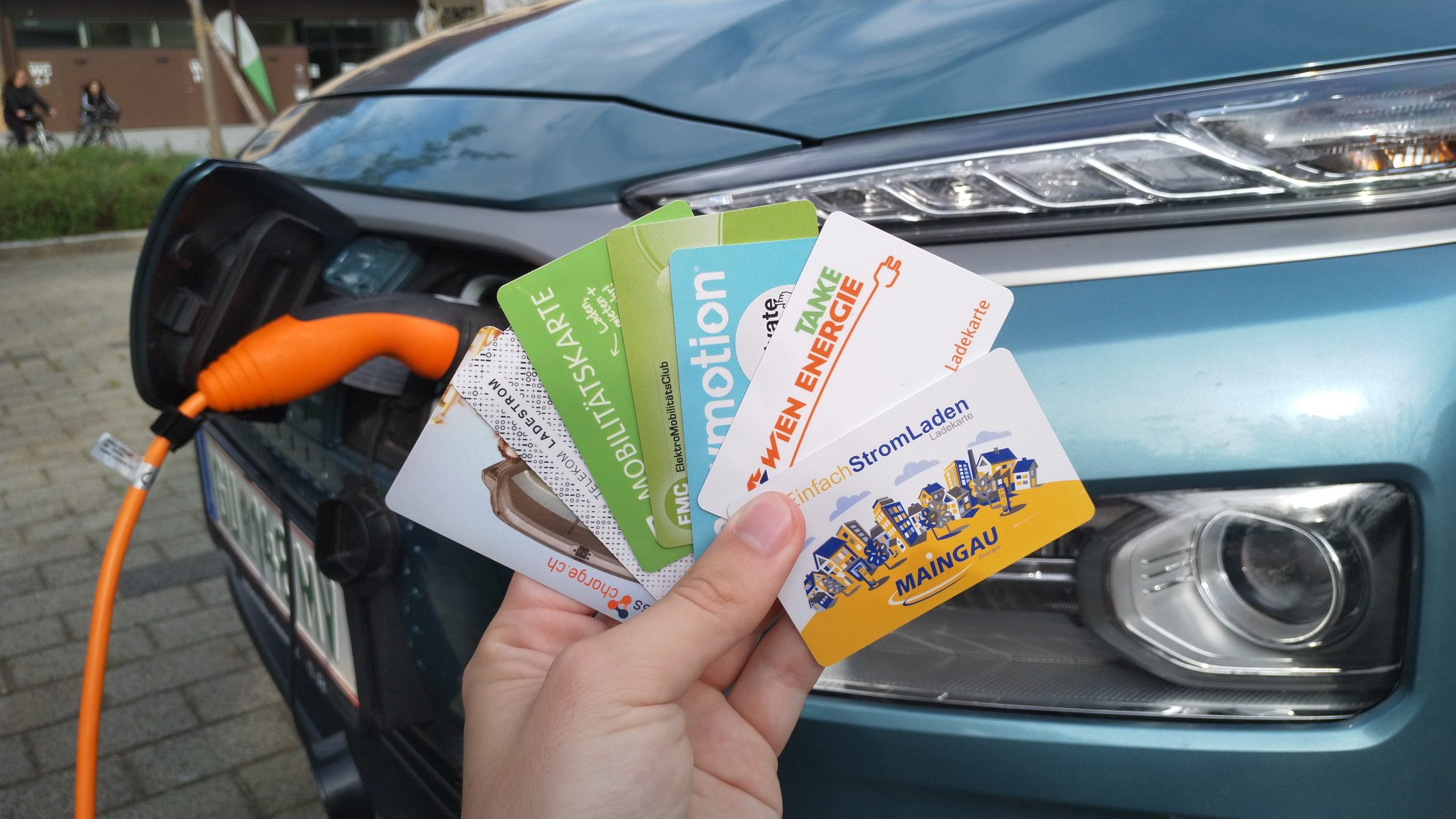 Charging cards and an electric vehicle, symbolizing Chargeprice's growth in 2022